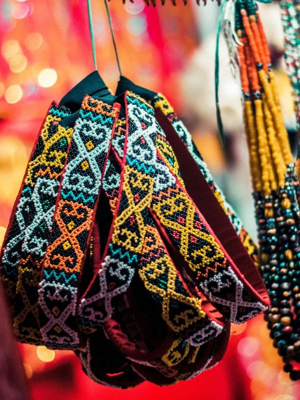 Colorful beaded necklaces with intricate patterns on a blurred background