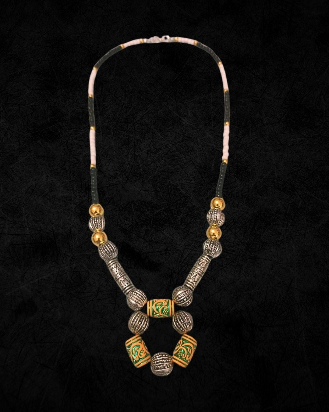 Necklace with gold and silver beads on a black background