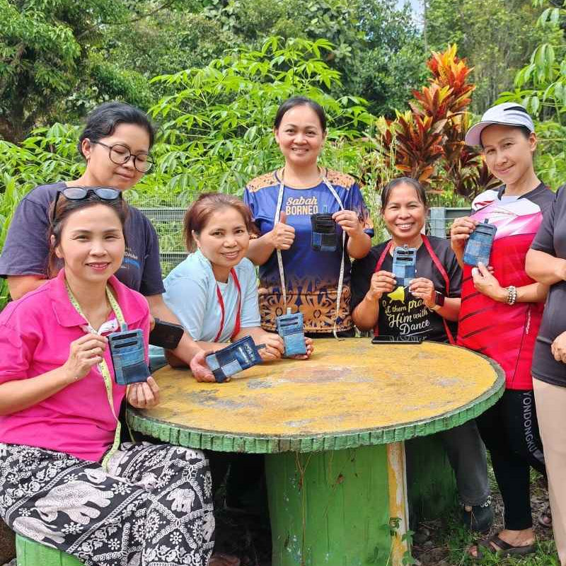 Rural women holding their handmade upcycled products