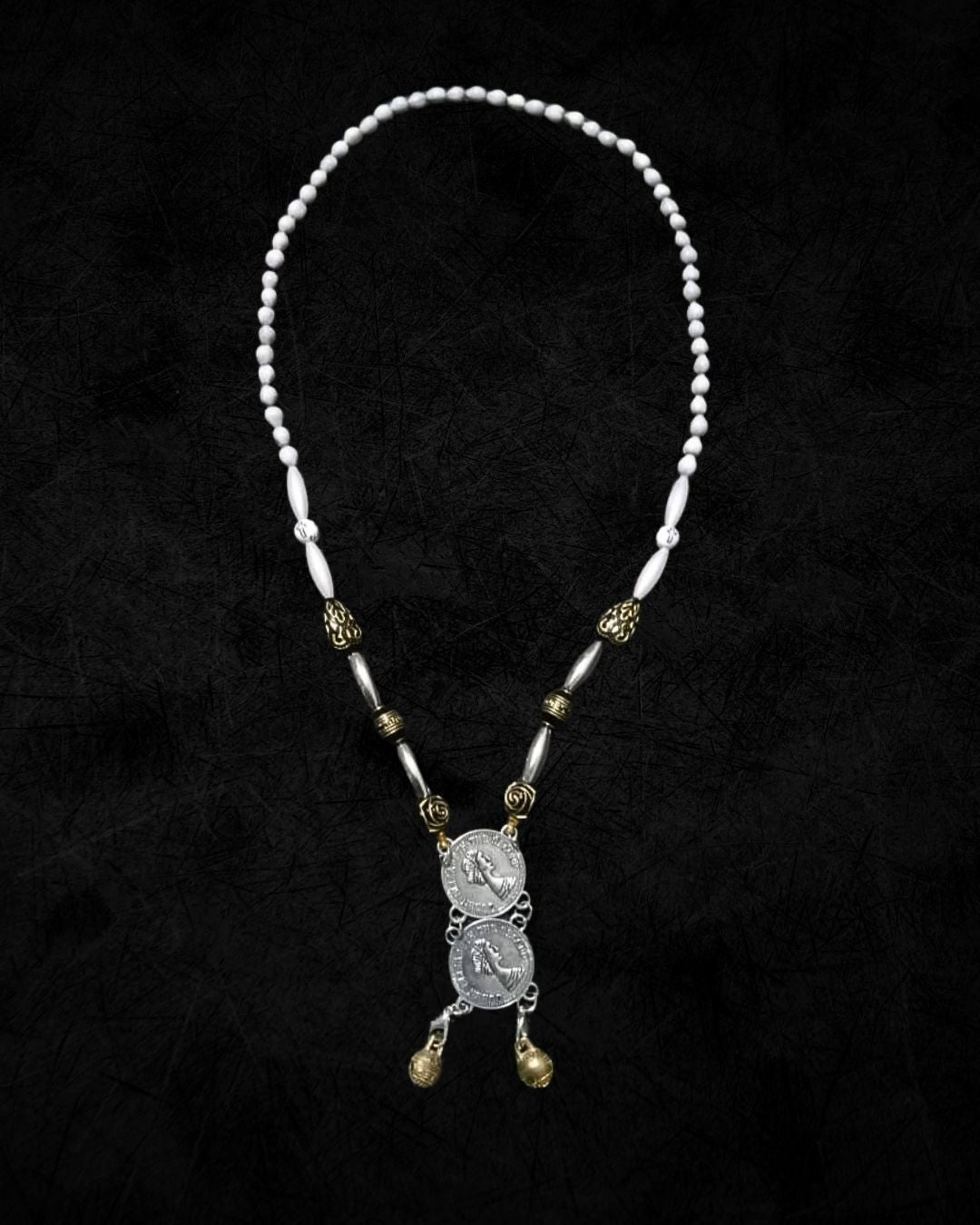 Necklace with beads and a pendant on a black background