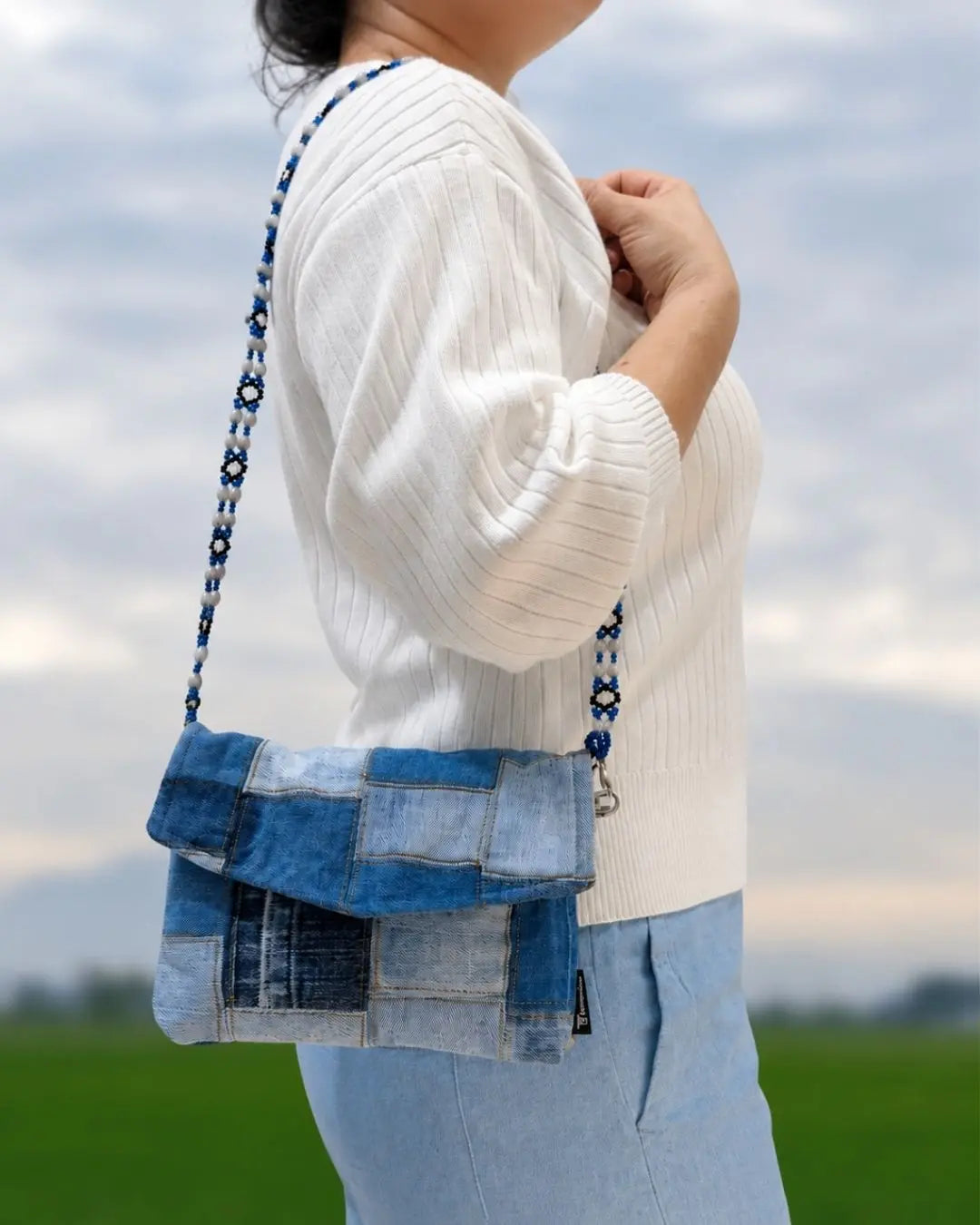 Styled as a sling bag with our beaded strap.
