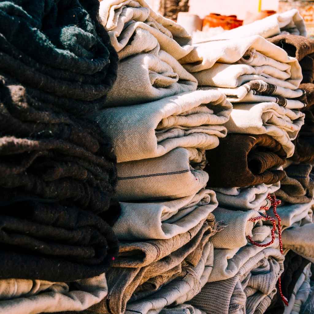 Stack of folded textiles in various colors