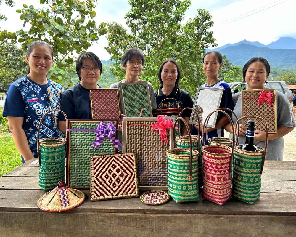 Group of women displaying their own handmade woven crafts. 