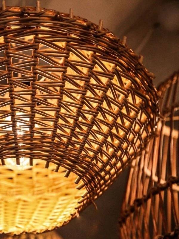 Wicker lampshade with warm glow on a dark background