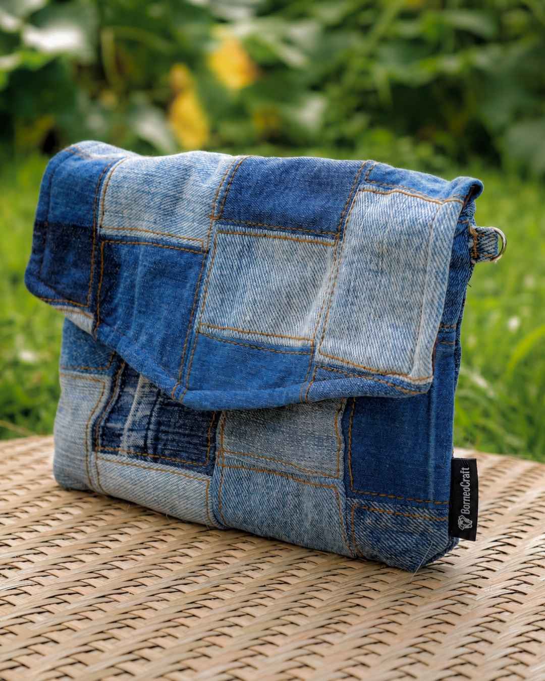 Side view of product with its envelope flap closure and patch work design.
