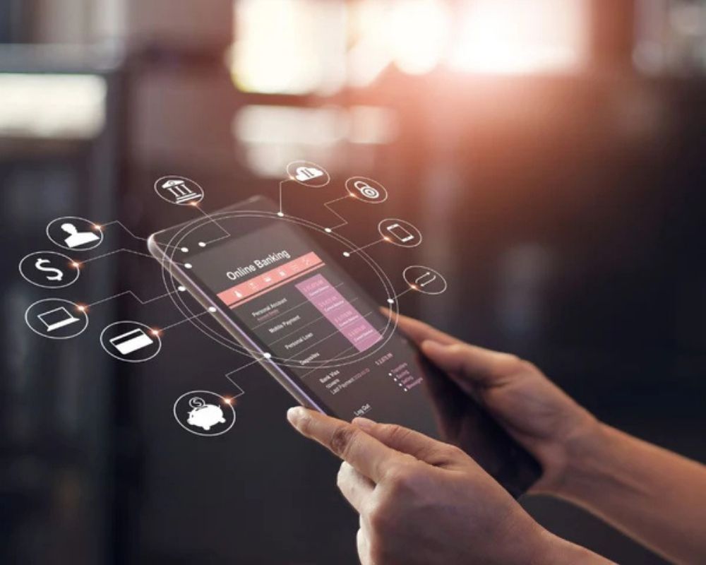 Person using a smartphone with a digital banking app interface on a blurred background