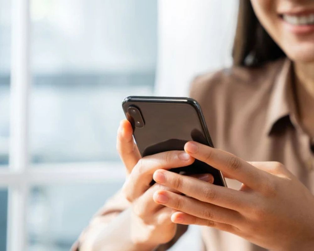 Person using a smartphone with a blurred background