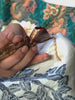 A person drawing batik cloth