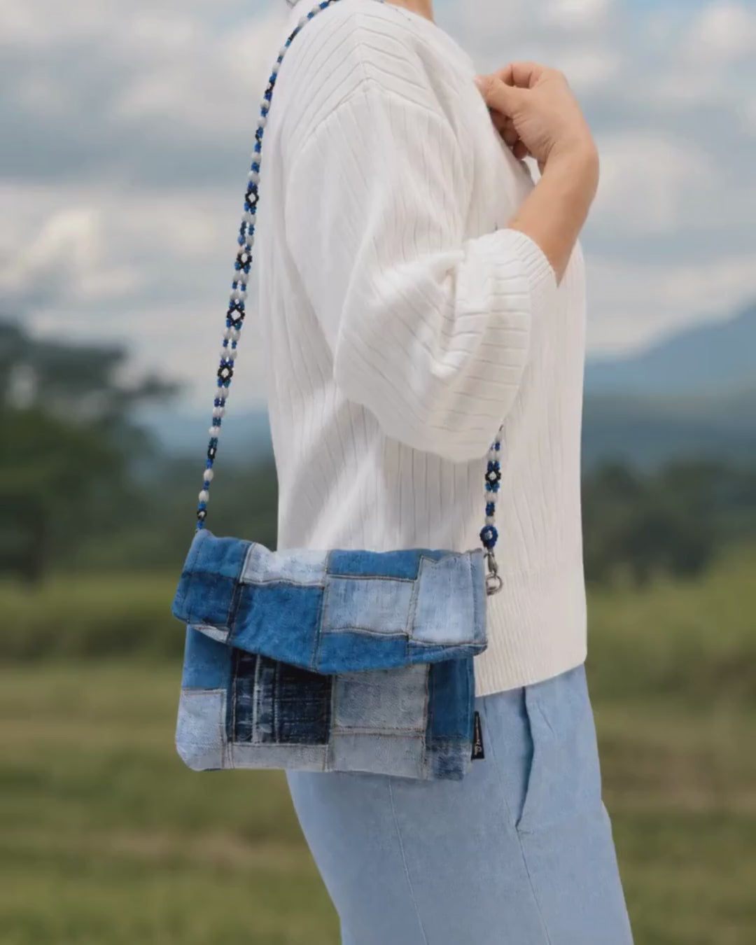 short video animation of a person carrying the envelope bag with beaded strap attached.